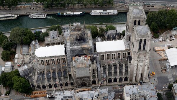 A view shows the damaged roof of Notre-Dame de Paris during restoration work, three months after a fire that devastated the cathedral in Paris - Sputnik International