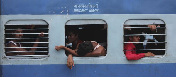 Indian migrant laborers sit inside a train as they prepare to leave the region, at a railway station in Jammu, India, Wednesday, Aug. 7, 2019 Indian migrant laborers sit inside a train as they prepare to leave the region, at a railway station in Jammu, India, Wednesday, Aug. 7, 2019 - Sputnik International