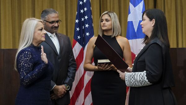 Justice Secretary Wanda Vazquez is sworn in as governor of Puerto Rico by Supreme Court Justice Maite Oronoz, in San Juan, Puerto Rico, Wednesday, Aug. 7, 2019. Vazquez took the oath of office early Wednesday evening at the Puerto Rican Supreme Court, which earlier in the day ruled that Pedro Pierluisi's swearing in last week was unconstitutional. Vazquez was joined by her daughter Beatriz Diaz Vazquez and her husband Judge Jorge Diaz. - Sputnik International