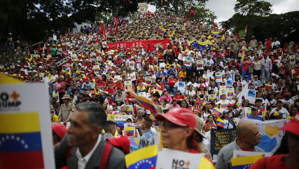Government supporters gather for a rally to protest against economic sanctions imposed by the administration of U.S. President Donald Trump, in Caracas, Venezuela, Saturday, Aug. 10, 2019. - Sputnik International
