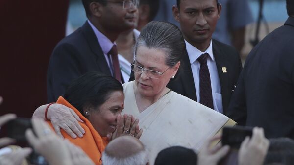 United Progressive Alliance chairperson Sonia Gandhi, center, hugs Bharatiya Janata Party leader Uma Bharati at the swearing in ceremony of Indian prime minister Narendra Modi and his cabinet at the forecourt of presidential palace in New Delhi, India, Thursday, May 30, 2019. - Sputnik International