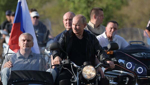 President Vladimir Putin riding Ural motorbike alongside Crimea's head Sergey Aksenov (in the sidecar). - Sputnik International