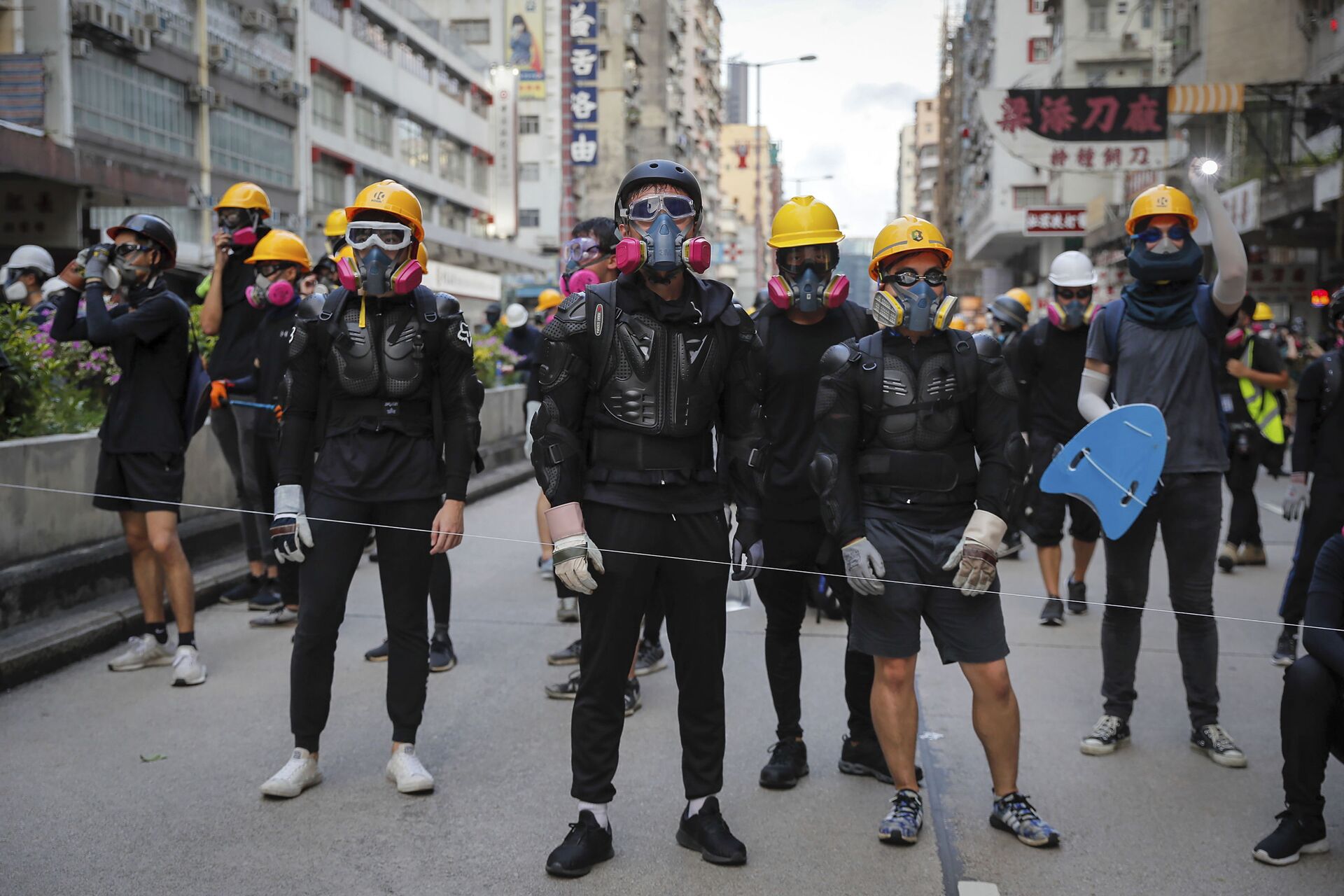 Protesters with protection gears face with riot policemen on a street during the anti-extradition bill protest in Hong Kong, Sunday, Aug. 11, 2019. Police fired tear gas late Sunday afternoon to try to disperse a demonstration in Hong Kong as protesters took over streets in two parts of the Asian financial capital, blocking traffic and setting up another night of likely showdowns with riot police. - Sputnik International, 1920, 24.09.2021