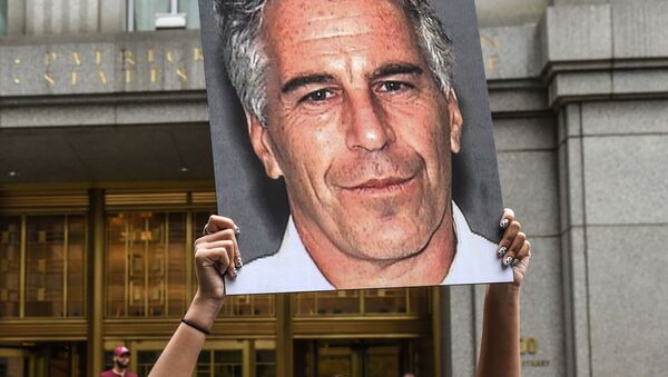 (FILES) In this file photo taken on July 8, 2019, a protest group called Hot Mess hold up photos of Jeffrey Epstein in front of the Federal courthouse on July 8, 2019 in New York City - Sputnik International