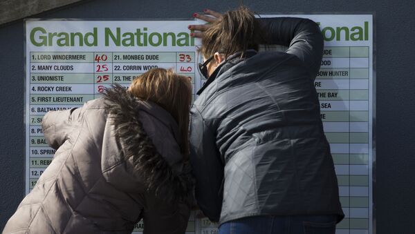 A bookmakers odds board is filled out before the Grand National horse race at Aintree Racecourse Liverpool, England, Saturday, April 11, 2015 - Sputnik International