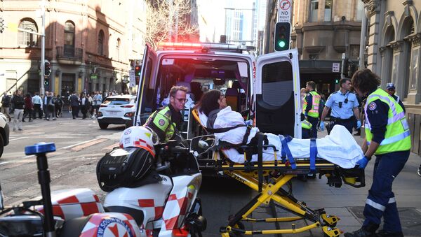A women is taken by ambulance from Hotel CBD at the corner of King and York Street in Sydney, Australia Tuesday, Aug. 13, 2019. Police and witnesses say a young man yelling about religion and armed with a knife has attempted to stab several people in downtown Sydney before being arrested, with one woman taken to a hospital.  - Sputnik International