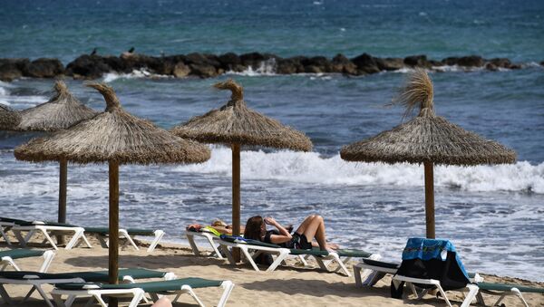 People sunbath on May 9, 2019 on a beach of the Spanish Balearic island of Majorca near Palma - Sputnik International