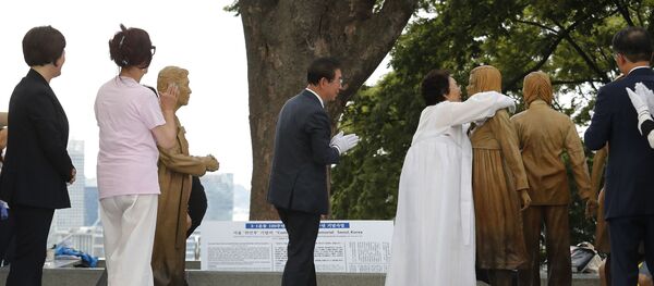 Lee Yong-soo, second from right, who was forced to serve for the Japanese troops as a sex slave during World War II, hugs a statue of a girl symbolising the issue of wartime comfort women during it unveiling ceremony in Seoul, South Korea, Wednesday, Aug. 14, 2019. Lee Yong-soo, second from right, who was forced to serve for the Japanese troops as a sex slave during World War II, hugs a statue of a girl symbolising the issue of wartime comfort women during it unveiling ceremony in Seoul, South Korea, Wednesday, Aug. 14, 2019. - Sputnik International