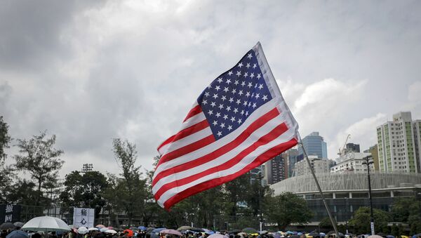 A U.S. flag flutters as people gather at Victoria Park to take part in an anti-extradition bill protest in Hong Kong, Sunday, Aug. 11, 2019. Protesters have begun gathering at the park in central Hong Kong for another day of demonstrations that have generally started peacefully but often ended in violent clashes with police. - Sputnik International