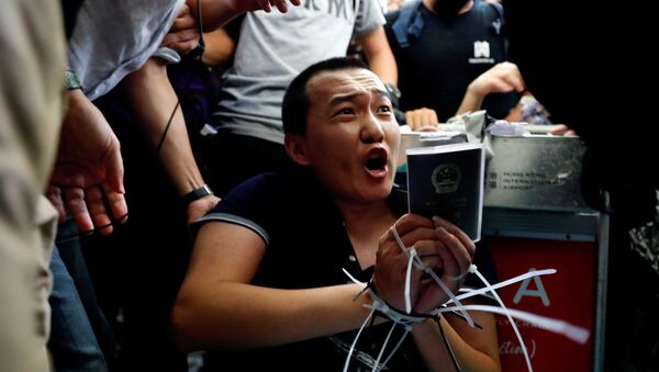 Fu Guohao, reporter of Chinese media Global Times website, is tied by protesters during a mass demonstration at the Hong Kong international airport, in Hong Kong, China, August 13, 2019.  - Sputnik International