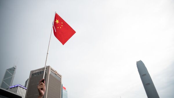 A Chinese flag is held at a rally in support of the police in Tamar Park outside the government headquarters in Hong Kong on July 20, 2019. - Sputnik International