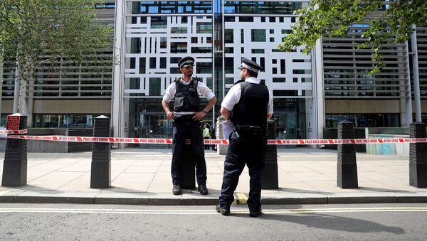 Police officers stand guard in front of the Home Office in London - Sputnik International