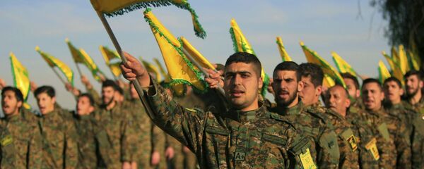 Hezbollah fighters hold flags as they attend the memorial of their slain leader Sheik Abbas al-Mousawi, who was killed by an Israeli airstrike in 1992 Hezbollah fighters hold flags as they attend the memorial of their slain leader Sheik Abbas al-Mousawi, who was killed by an Israeli airstrike in 1992 - Sputnik International