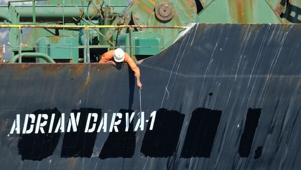A crew member checks the new name of Iranian oil tanker Adrian Darya, formerly known as Grace 1, off the coast of Gibraltar on August 18, 2019. - Gibraltar rejected a US demand to seize the Iranian oil tanker at the centre of a diplomatic dispute as it prepared to leave the British overseas territory after weeks of detention. - Sputnik International