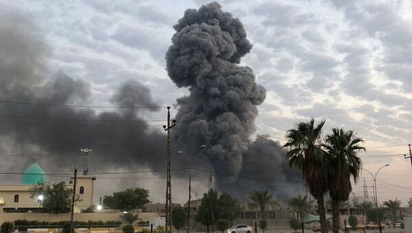 In this 12 August  2019 file photo, plumes of smoke rise after an explosion at a military base southwest of Baghdad, Iraq. A fact-finding committee appointed by the Iraqi government to investigate a massive munitions depot explosion near the capital Baghdad has concluded that the blast was the result of a drone strike. A copy of the report was obtained by The Associated Press on Wednesday, 21 August 2019 - Sputnik International
