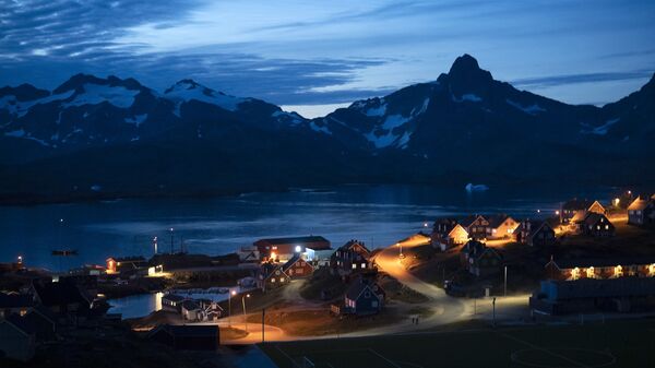 In this photo taken late Friday, Aug. 16, 2019, homes are illuminated after the sunset in Tasiilaq, Greenland.  - Sputnik International