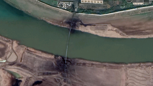 A closeup of the Pyongsan tailings pipe across the Ryesong River, showing leaking at both ends - Sputnik International