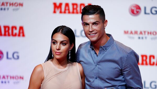 Soccer Football - Cristiano Ronaldo receives the MARCA Legend award - Reina Victoria Theater, Madrid, Spain - July 29, 2019   Cristiano Ronaldo poses with partner Georgina Rodriguez and the MARCA Legend award   - Sputnik International