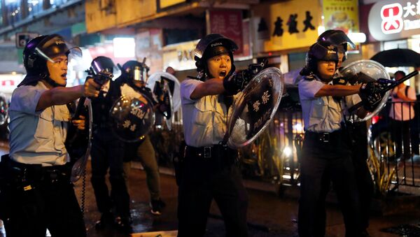 Police officers point their guns towards anti-extradition bill protesters after a clash, at Tsuen Wan, in Hong Kong, China August 25, 2019 - Sputnik International