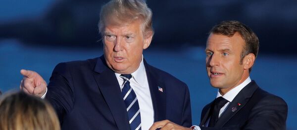 French President Emmanuel Macron talks with U.S. President Donald Trump after posing for a family photo with invited guests during the G7 summit in Biarritz, France, August 25, 2019. - Sputnik International