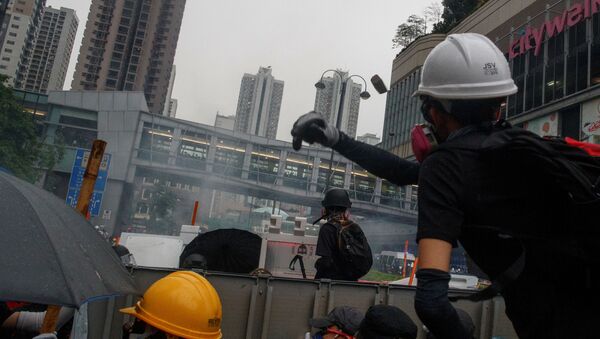 An anti-extradition bill protester throws a stone at police during clashes in Tsuen Wan in Hong Kong, China August 25, 2019. - Sputnik International