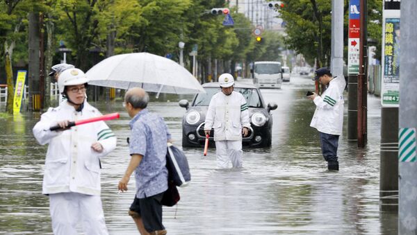 Police officers check a submerged street at a flooded area in Saga, Saga prefecture, southern Japan August 28, 2019, in this photo taken by Kyodo. - Sputnik International