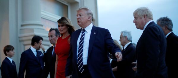 U.S. President Donald Trump, First Lady Melania Trump and Britain's Prime Minister Boris Johnson react after the family photo with invited guests at the G7 summit in Biarritz, France, August 25, 2019 - Sputnik International