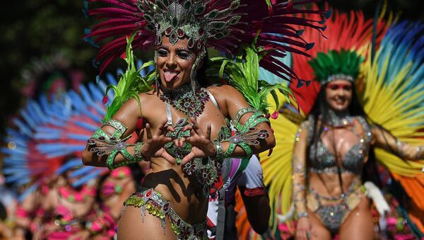 Performers in costumes take part in the carnival on the main Parade day of the Notting Hill Carnival in west London on August 26, 2019. - Sputnik International