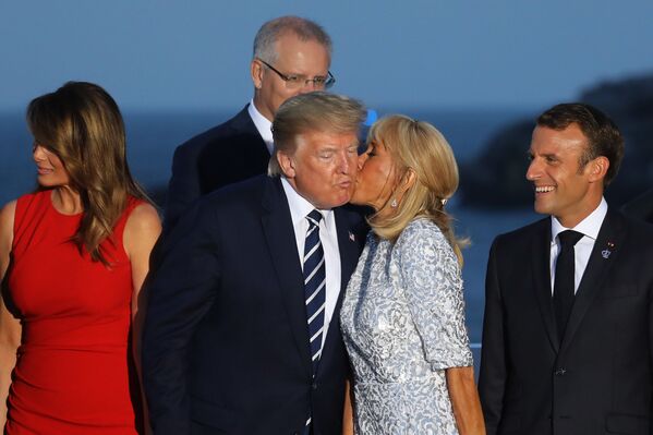 French President's wife Brigitte Macron kisses US President Donald Trump, flanked by US First Lady Melania Trump and France's President Emmanuel Macron, prior to a family picture with G7 leaders and guests, on the second day of the annual G7 summit in Biarritz, south-west France on August 25, 2019. French President's wife Brigitte Macron kisses US President Donald Trump, flanked by US First Lady Melania Trump and France's President Emmanuel Macron, prior to a family picture with G7 leaders and guests, on the second day of the annual G7 summit in Biarritz, south-west France on August 25, 2019. - Sputnik International