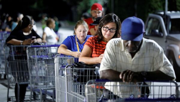 Shoppers wait in line for a Sam's Club store to open before sunrise, as people rushed to buy supplies ahead of the arrival of Hurricane Dorian in Kissimmee, Florida, U.S. August 30, 2019 - Sputnik International