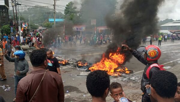 People burn tires during a protest at a road in Manokwari, West Papua, Indonesia, August 19, 2019 in this photo taken by Antara Foto. Antara Foto/Toyiban/via REUTERS  - Sputnik International