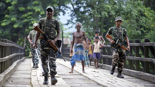 Indian security personnel patrol on a road ahead of the publication of the final draft of the National Register of Citizens (NRC) at Kachari Para village, in Hojai district, northeastern state of Assam, India August 30, 2019. - Sputnik International