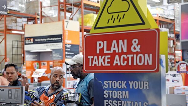 A worker at Home Depot helps customers with storm supplies as people rushed to stock up on necessities ahead of the arrival of Hurricane Dorian in Kissimmee, Florida, U.S. August 30, 2019.  - Sputnik International