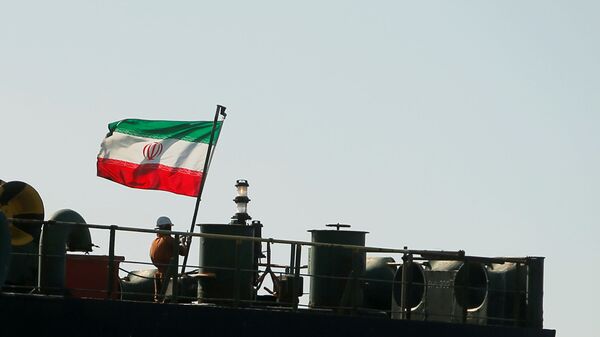 A crew member raises the Iranian flag on the Iranian oil tanker Adrian Darya 1, previously named Grace 1, as it sits anchored after the Supreme Court of the British territory lifted its detention order, in the Strait of Gibraltar, Spain, 18 August 2019. - Sputnik International