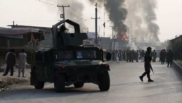 Policemen keep watch as angry Afghan protesters burn tires and shout slogans at the site of a blast in Kabul, Afghanistan September 3, 2019. - Sputnik International