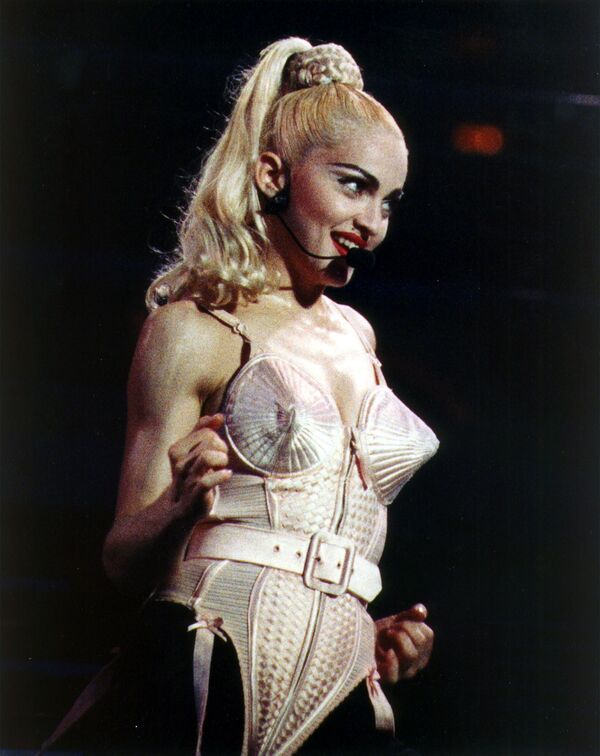 In this file photo from 3 December 1990, Madonna wears a bra top designed by Jean Paul Gaultier as she performs during her Blonde Ambition tour, in Philadelphia. - Sputnik International