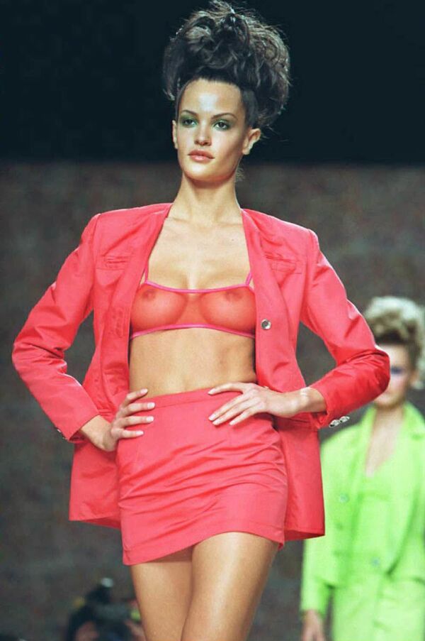 A model wears a red jacket and matching skirt over a see-through red bra at the Todd Oldham Spring 1996 fashion show 31 October in New York.  - Sputnik International