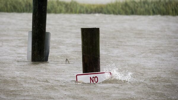 A sign at the Lazaretto Creek boat ramp as is nearly underwater at high tide as Hurricane Dorian makes its way up the east coast, Wednesday, Sept. 4, 2019, toward Tybee Island, Ga. Dorian is forecast to bring storm surge and tropical storm force winds the barrier island. (AP Photo/Stephen B. Morton) - Sputnik International