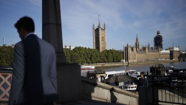 A pedestrian walks up a staircase on the southern bank of the River Thames with Houses of Parliament seen in the background in London on September 2, 2019 - Sputnik International