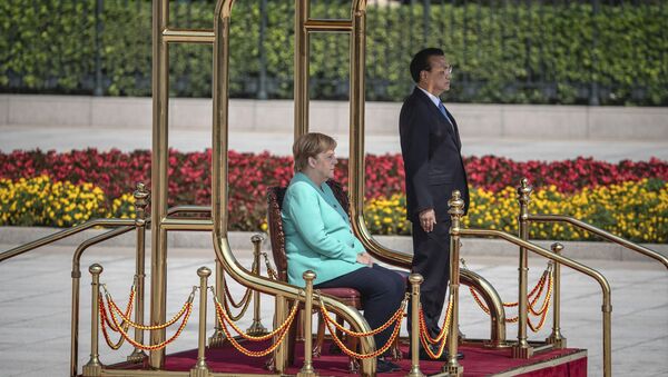 Chinese Premier Li Keqiang, right, and German Chancellor Angela Merkel listen to their countries national anthems during a welcome ceremony at the Great Hall of the People in Beijing Friday, Sept. 6,  2019 - Sputnik International