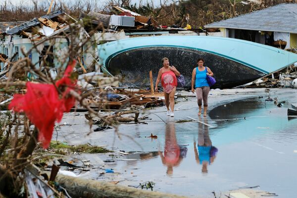 Women walk through the rubble in the aftermath of Hurricane Dorian on the Great Abaco island town of Marsh Harbour, Bahamas, September 3, 2019.  - Sputnik International