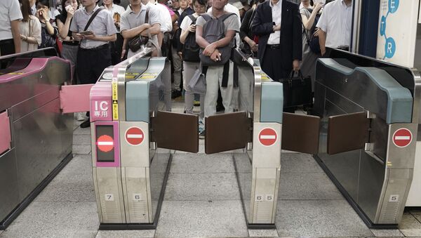 Commuters wait for automatic ticket gates to open at Shinjuku Station Monday, Sept. 9, 2019, in Tokyo. A powerful typhoon has passed over Tokyo, halting major train lines affecting morning rush-hour commuters and knocking over scaffolding and causing other damage but no reported deaths. - Sputnik International