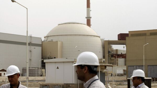 In this file photo taken on February 25, 2009, Iranian technicians walk outside the building housing the reactor of Bushehr nuclear power plant at the Iranian port town of Bushehr, 1200 Kms south of the capital Tehran. - Sputnik International