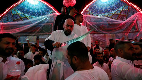  Shi'ite Muslims men flagellate themselves during a ceremony marking Ashura in the holy city of Kerbala, Iraq, September 10, 2019 - Sputnik International