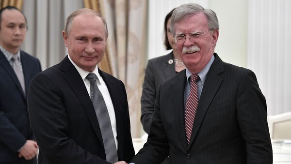Russian President Vladimir Putin and US National Security Advisor John Bolton (right) during the meeting, October 23, 2018. - Sputnik International