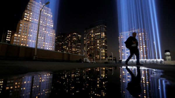 A man walks by the Tribute in Light, lit to commemorate the 18th anniversary of September 11, 2001 attacks in New York City, U.S., September 10, 2019 - Sputnik International