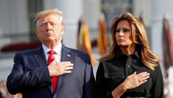 U.S. President Donald Trump and first lady Melania Trump observe a moment of silence to mark the 18th anniversary of September 11 attacks on the South Lawn of the White House in Washington, U.S., September 11, 2019 - Sputnik International