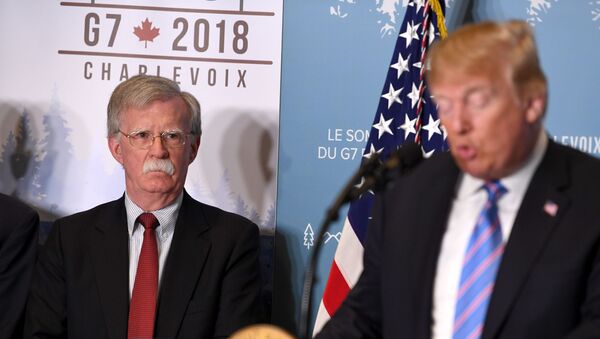 National Security Advisor John Bolton listens as US President Donald Trump speaks to reporters on June 9, 2018, during the G7 Summit - Sputnik International