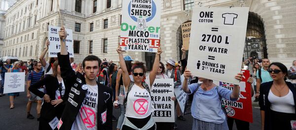 Extinction Rebellion protestors demonstrate against London Fashion Week near the Foreign and Commonwealth office, where Victoria Beckham was showing her latest designs, in London, Britain, September 15, 2019. REUTERS/Peter Nicholls Extinction Rebellion protestors demonstrate against London Fashion Week near the Foreign and Commonwealth office, where Victoria Beckham was showing her latest designs, in London, Britain, September 15, 2019. REUTERS/Peter Nicholls - Sputnik International
