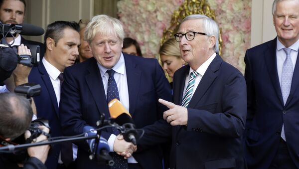 European Commission President Jean-Claude Juncker, center right, speaks with the media as he shakes hands with British Prime Minister Boris Johnson prior to a meeting at a restaurant in Luxembourg, Monday, Sept. 16, 2019 - Sputnik International